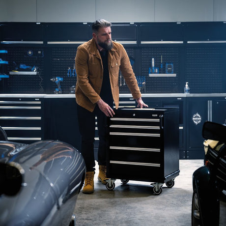 Man pushing a Bunker tool chest in a workshop setting