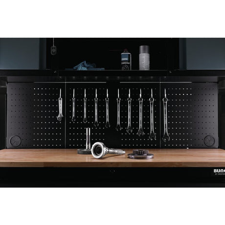 Bunnker Black pegboard with tools on a wooden surface, featuring the BUNN logo.