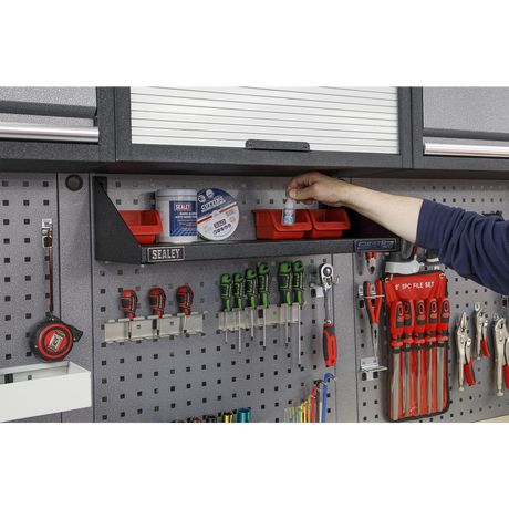 Sealey Superline Pro Person organizing tools in a Sealey garage storage unit.