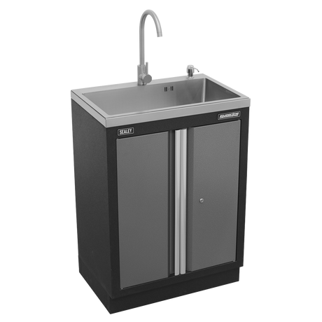 Stainless steel sink with faucet in a black cabinet on a white background