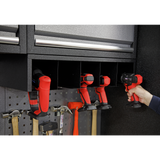 Person using a cordless drill in a well-organized garage tool cabinet.