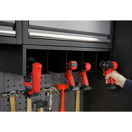 Person using a cordless drill in a well-organized garage tool cabinet.