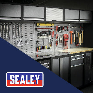 Organized garage workspace with tools on a pegboard and Sealey logo.